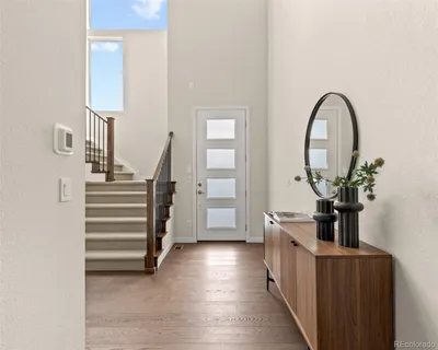 a view of entryway and hall with wooden floor