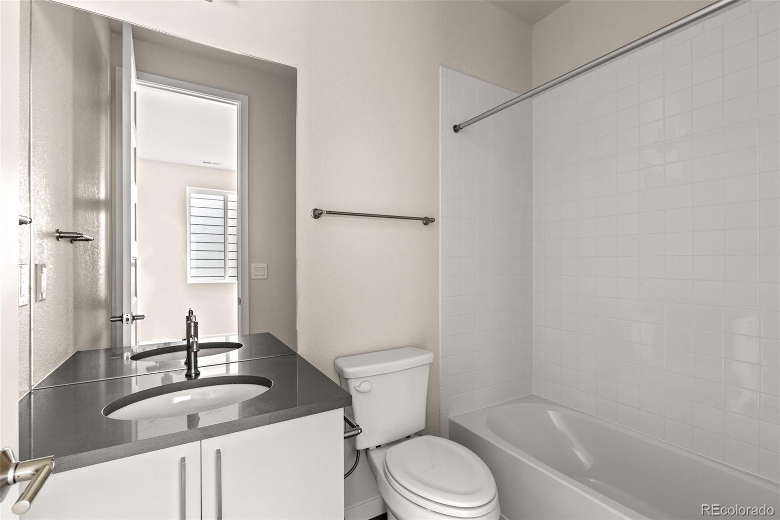 11332 Alla Breve Lone Tree, CO 80134 - Photo 31 of 50 a bathroom with a granite countertop sink toilet and shower