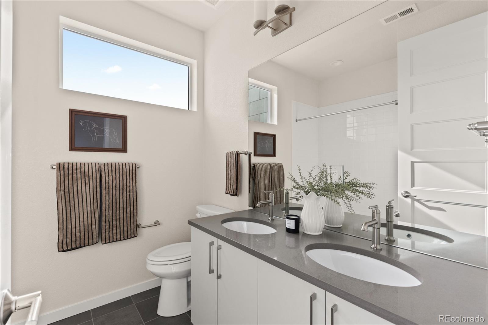 11332 Alla Breve Lone Tree, CO 80134 - Photo 33 of 50 a bathroom with a granite countertop toilet sink and mirror