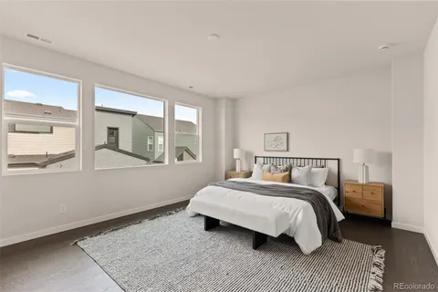 a bedroom with a bed and glass window