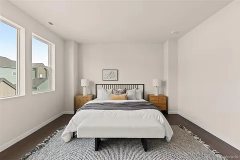 a bed sitting in a bedroom next to a window