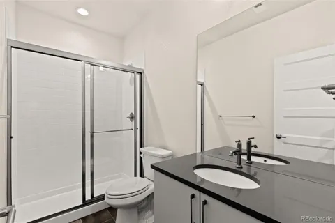 a bathroom with a sink toilet and a mirror