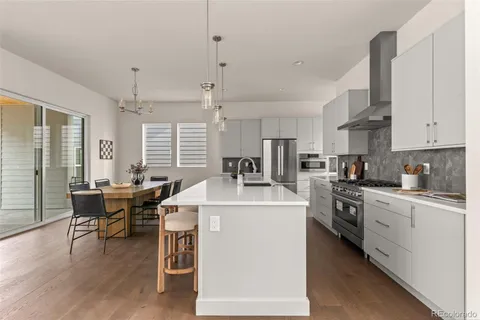 a kitchen that has a lot of cabinets in it and appliances