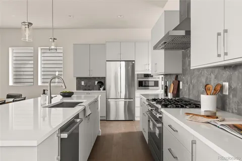 a kitchen with a sink stove and refrigerator