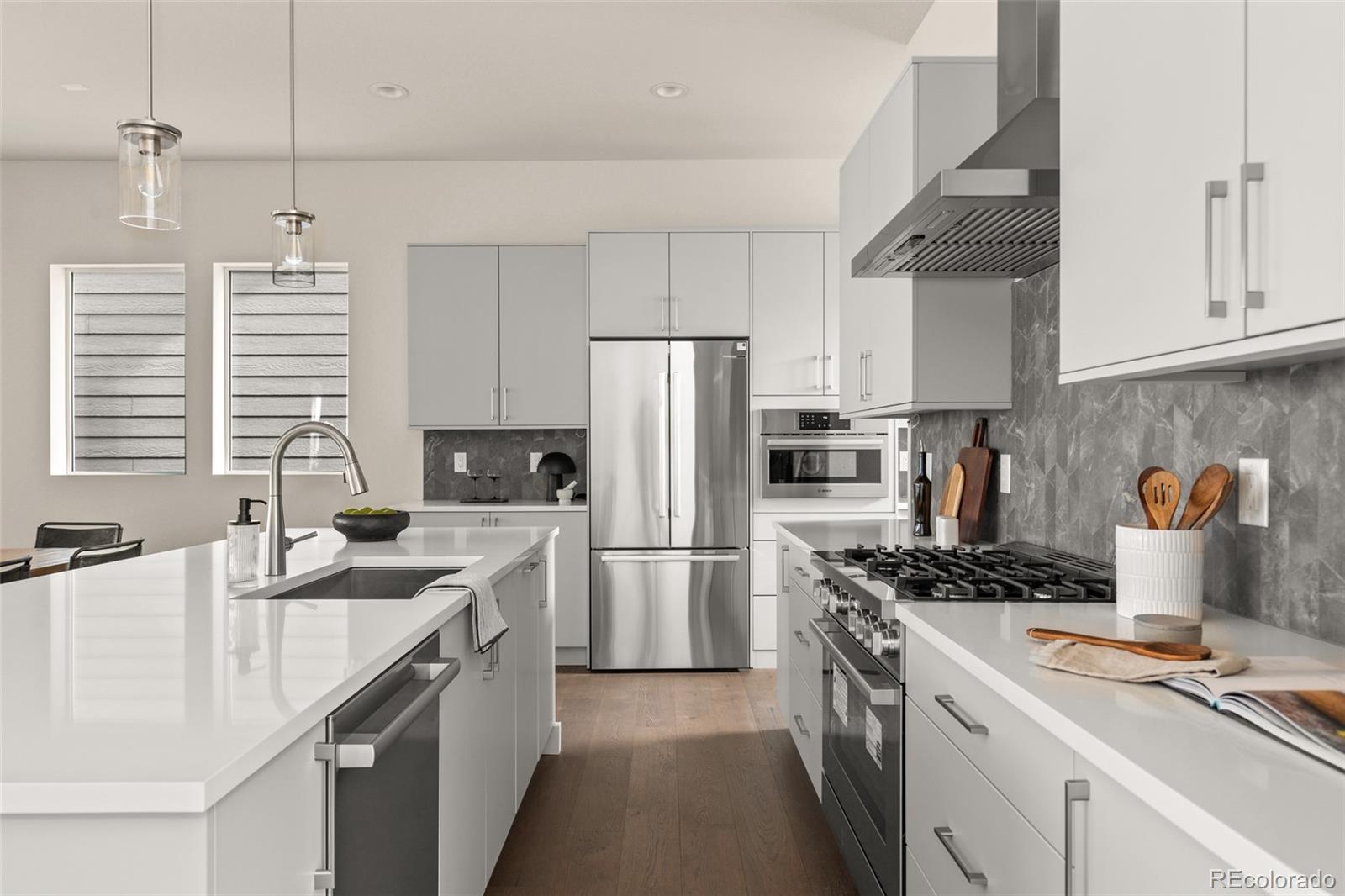 11332 Alla Breve Lone Tree, CO 80134 - Photo 8 of 50 a kitchen with a sink stove and refrigerator