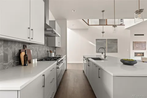 a kitchen with stainless steel appliances a sink stove and cabinets