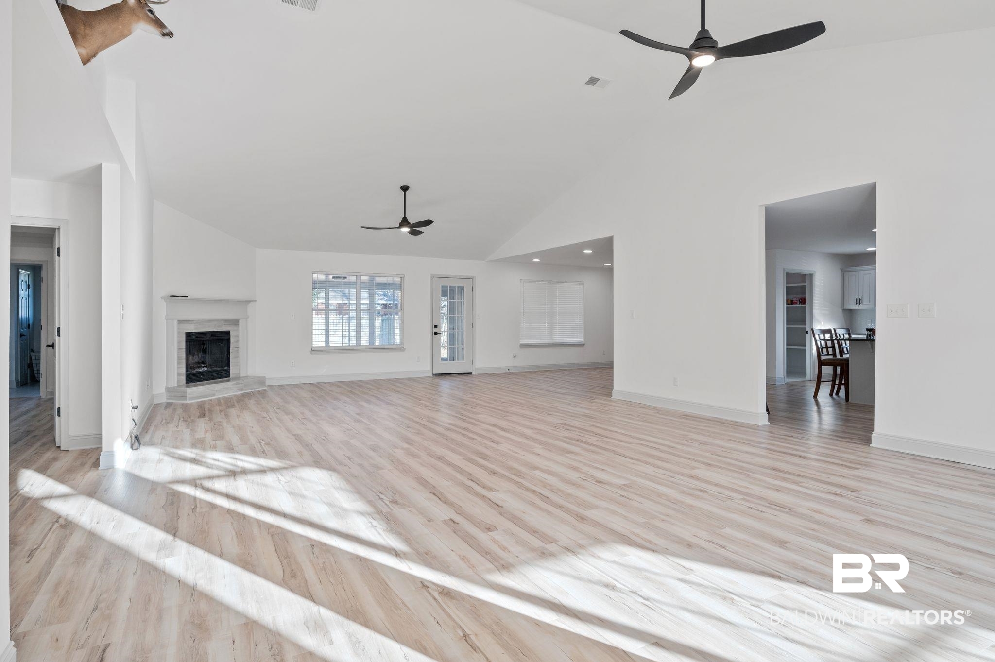 136 Destrehan Road Fairhope, AL 36532 - Photo 4 of 44 Unfurnished living room with light hardwood / wood-style flooring, high vaulted ceiling, and ceiling fan