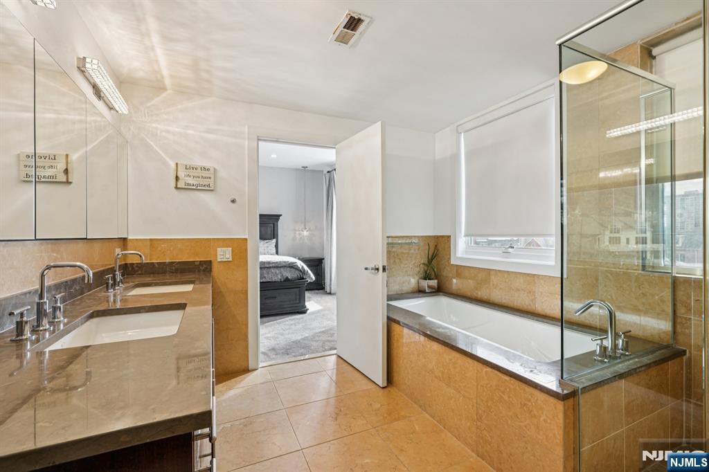 25 Vela Way Edgewater, NJ 07020 - Photo 19 of 41 a spacious bathroom with a tub sink and mirror