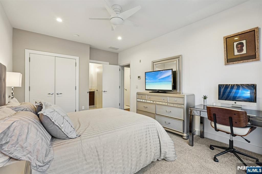 25 Vela Way Edgewater, NJ 07020 - Photo 22 of 41 a bedroom with a bed and a flat screen tv
