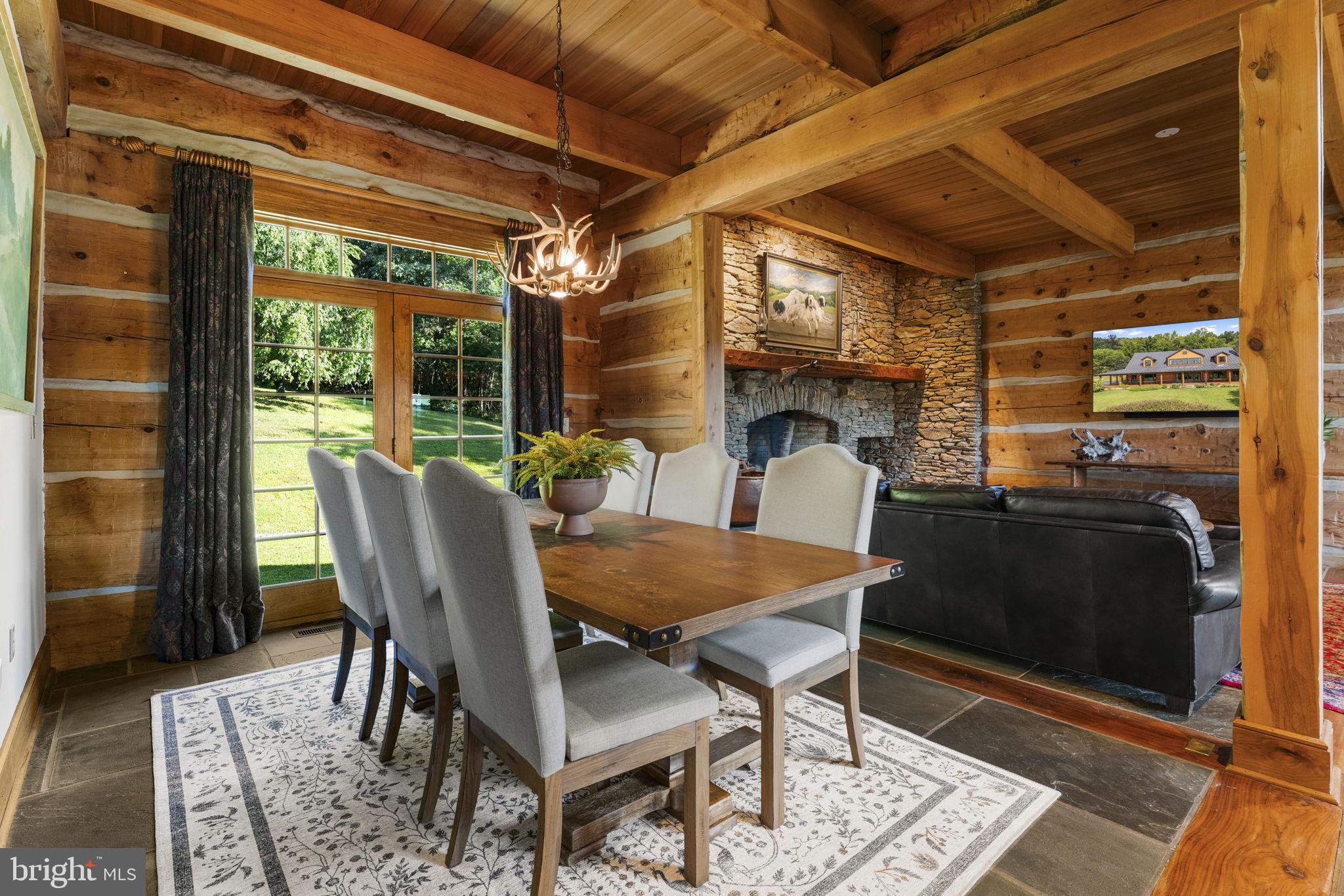 156 Bear Wallow Road Huntly, VA 22640 - Photo 25 of 68 a dining room with furniture and a floor to ceiling window