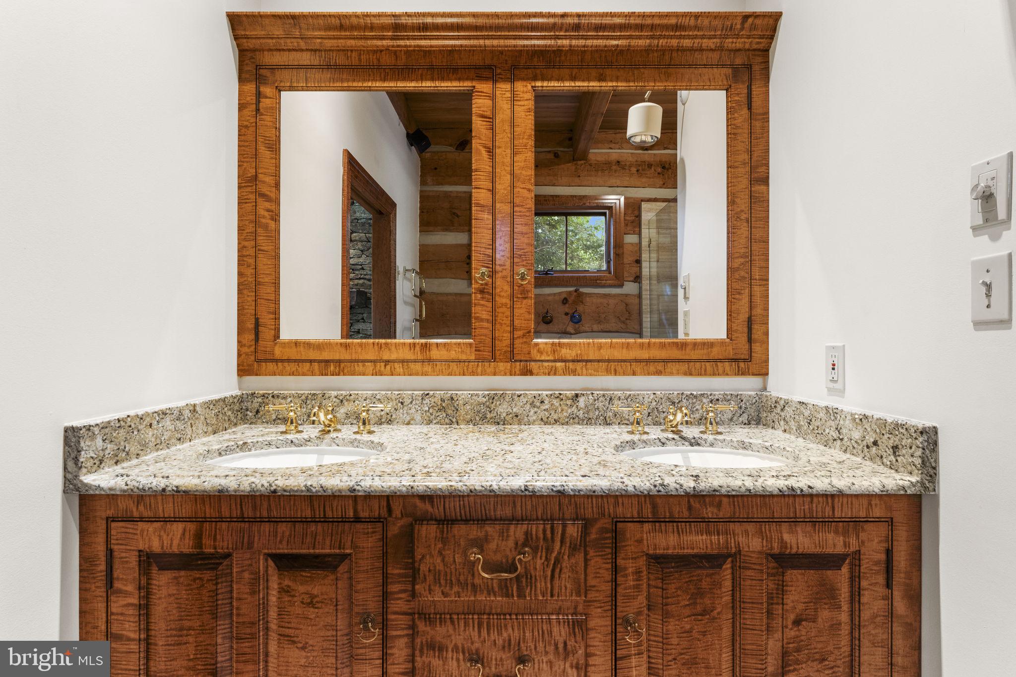 156 Bear Wallow Road Huntly, VA 22640 - Photo 36 of 68 a bathroom with a granite countertop sink and a large mirror