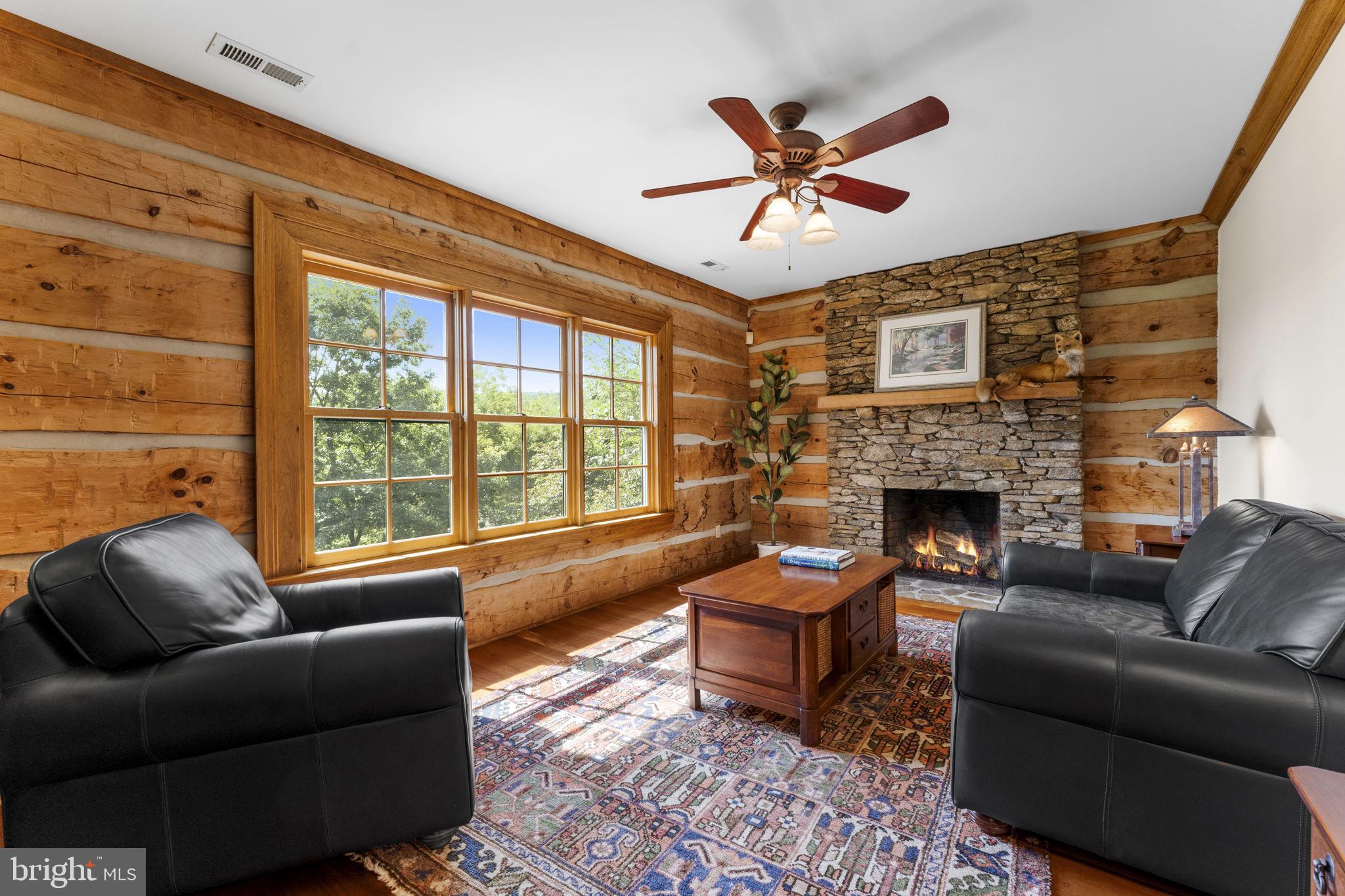 156 Bear Wallow Road Huntly, VA 22640 - Photo 53 of 68 a living room with furniture a fireplace and a floor to ceiling window