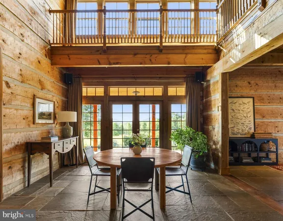 a dining room with furniture and a floor to ceiling window