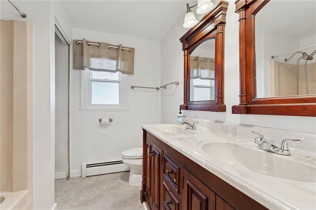 611 Alexander Avenue Monaca, PA 15061 - Photo 23 of 34 a bathroom with a double vanity sink and a mirror