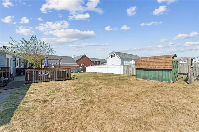 a swimming pool with yard and mountain view in back