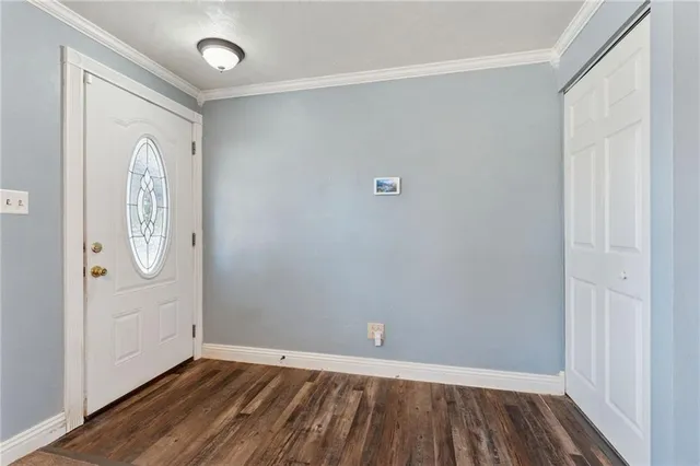 a view of a room with wooden floor and white walls