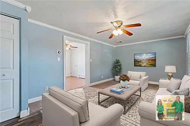 a living room with furniture and a chandelier