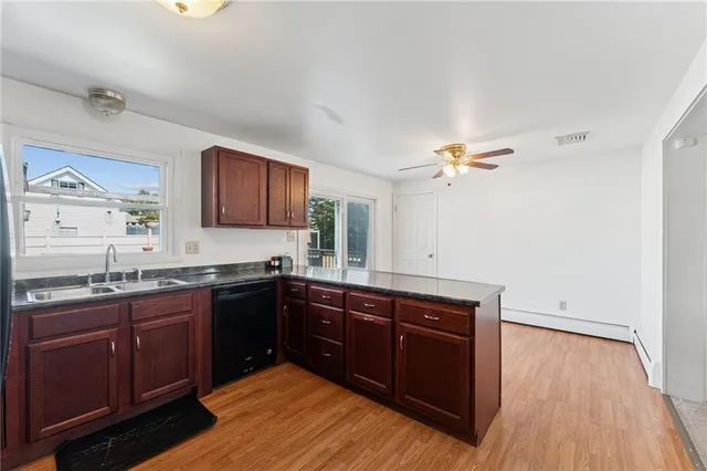 a kitchen with granite countertop a sink and wooden cabinets