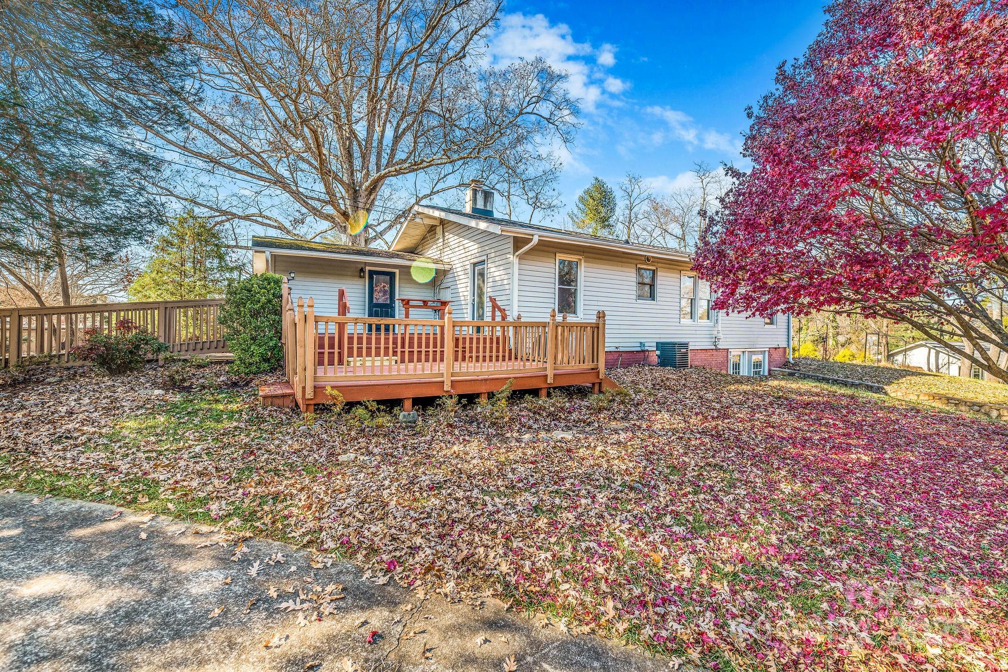 107 Woodland Church Road Clyde, NC 28721 - Photo 1 of 42 a backyard of a house with a garden and deck