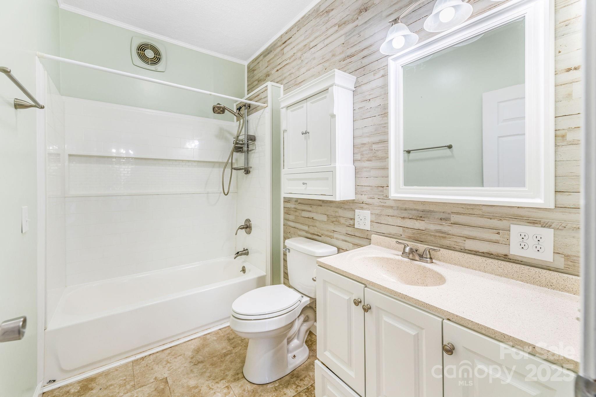 107 Woodland Church Road Clyde, NC 28721 - Photo 12 of 42 a bathroom with a sink toilet a shower and bathtub