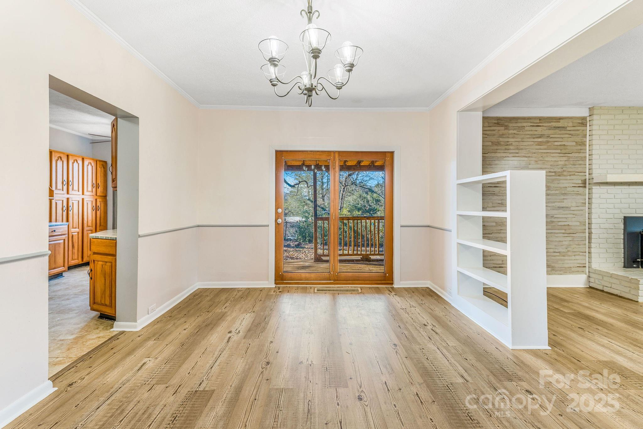 107 Woodland Church Road Clyde, NC 28721 - Photo 13 of 42 a view of a big room with wooden floor and windows
