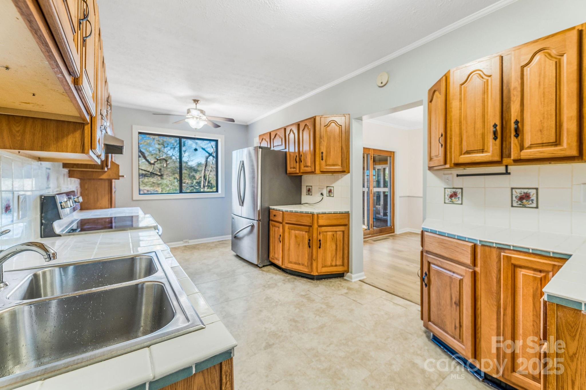 107 Woodland Church Road Clyde, NC 28721 - Photo 16 of 42 a kitchen with stainless steel appliances a sink and a refrigerator