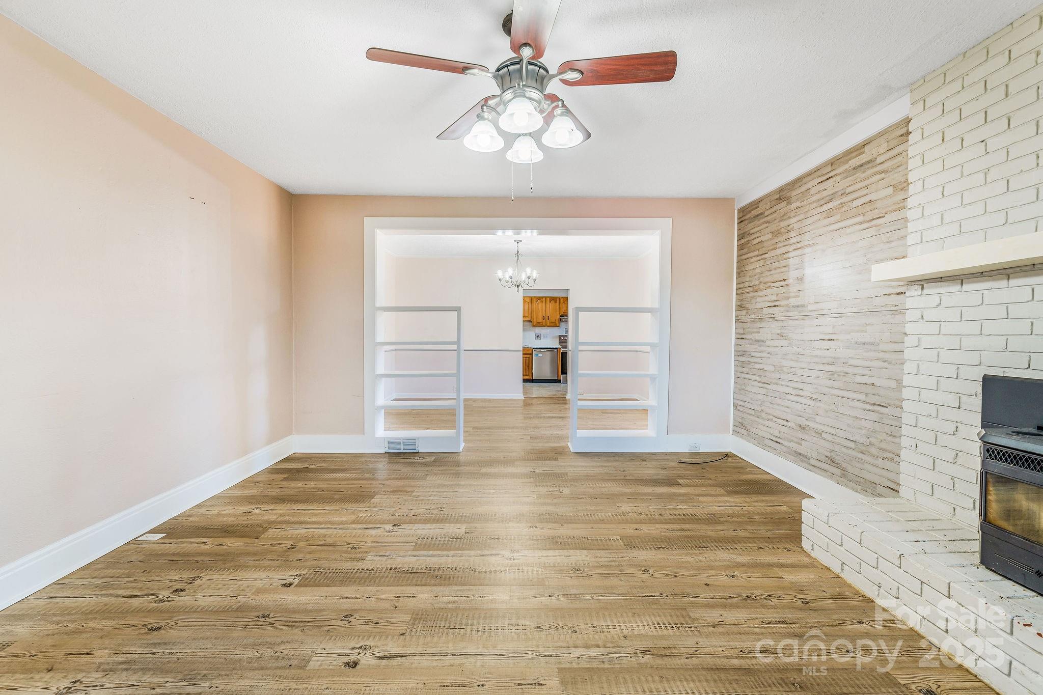 107 Woodland Church Road Clyde, NC 28721 - Photo 19 of 42 a view of empty room with wooden floor and fan