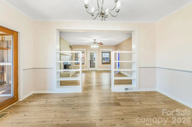 a view of a living room with hardwood floor and chandelier