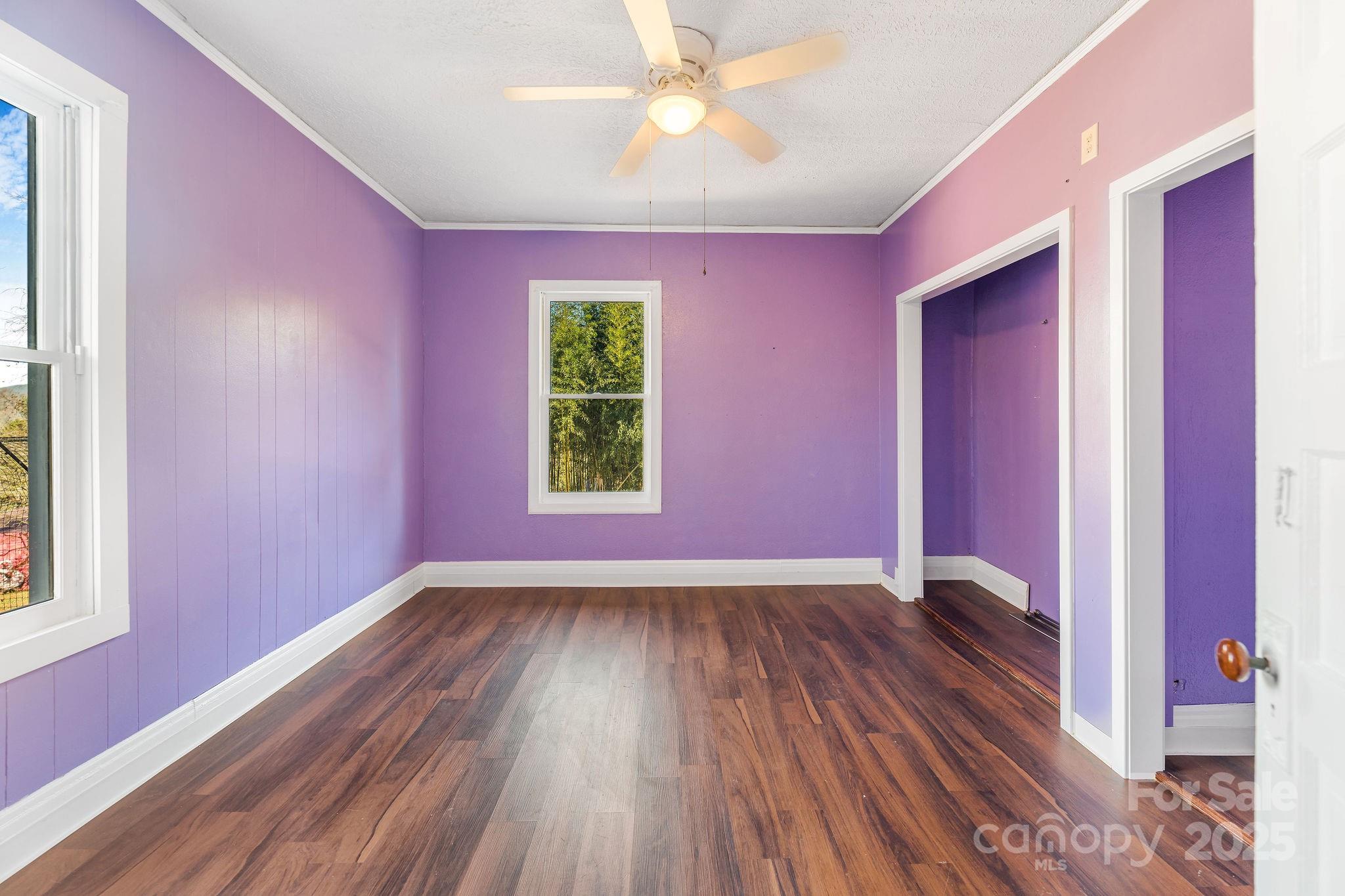 107 Woodland Church Road Clyde, NC 28721 - Photo 22 of 42 a view of an empty room with window and wooden floor