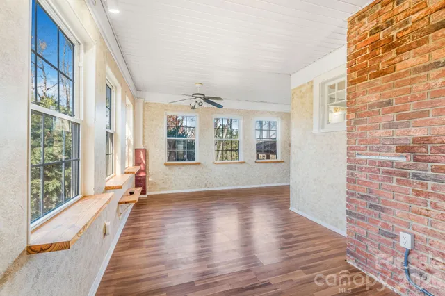 a view of an entryway with wooden floor and a livingroom view
