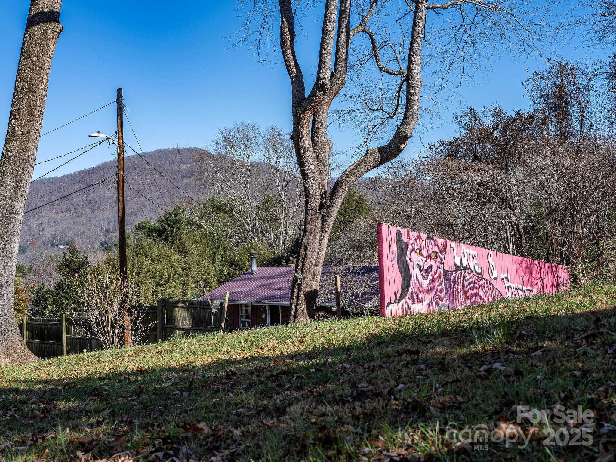 107 Woodland Church Road Clyde, NC 28721 - Photo 40 of 42 a sign that is sitting on a wooden fence