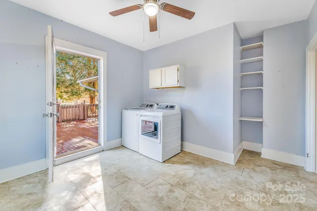 a view of a livingroom with a window and a kitchen