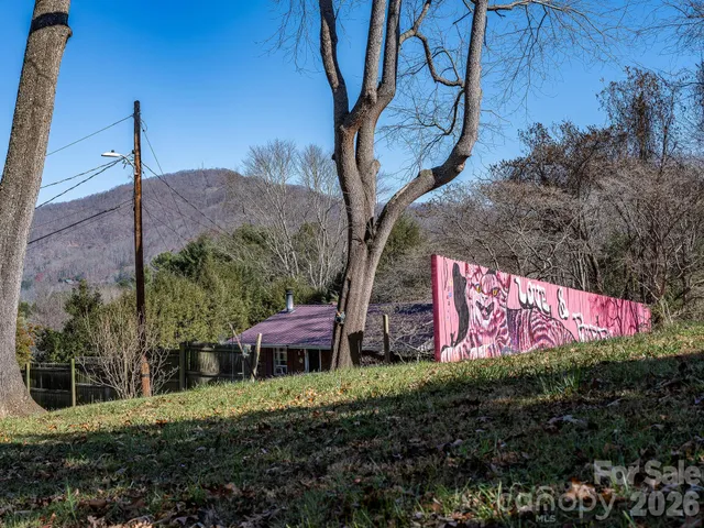 a sign that is sitting on a wooden fence