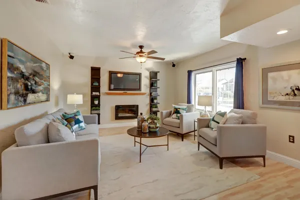 a living room with furniture a fireplace and a flat screen tv