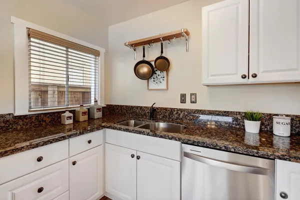 a kitchen with a sink and cabinets