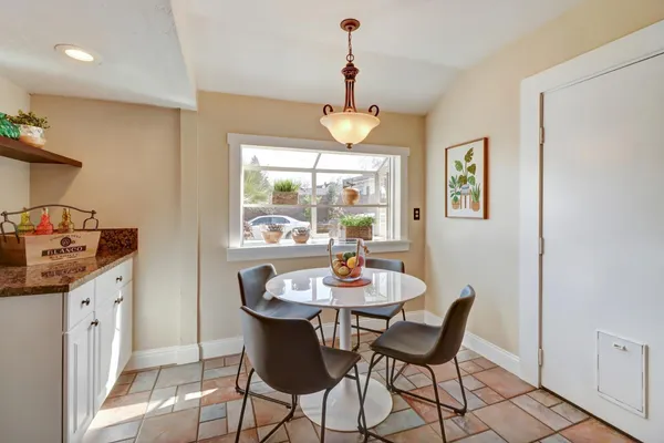 a dining room with furniture a window and wooden floor