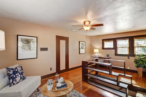 a living room with furniture and wooden floor