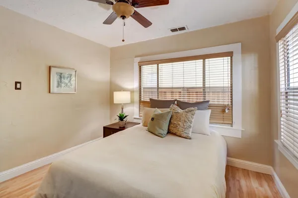 a bedroom with a large bed and a window