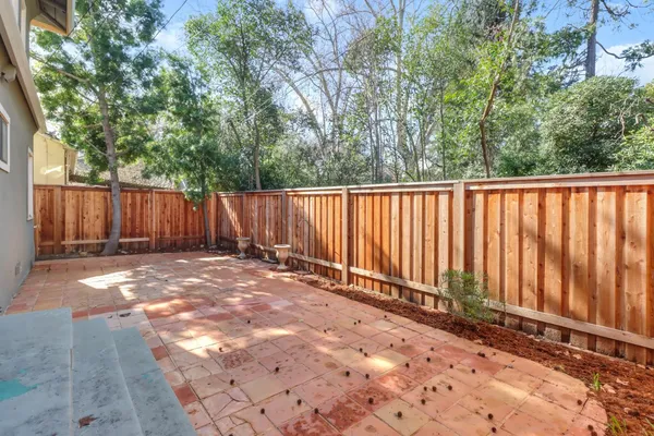 a view of a backyard with wooden fence