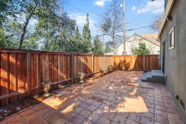 a view of backyard with wooden fence