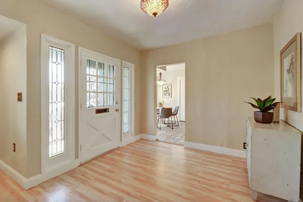 a view of a room with wooden floor and bench