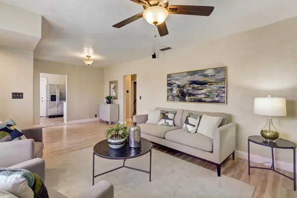 a living room with furniture and a chandelier