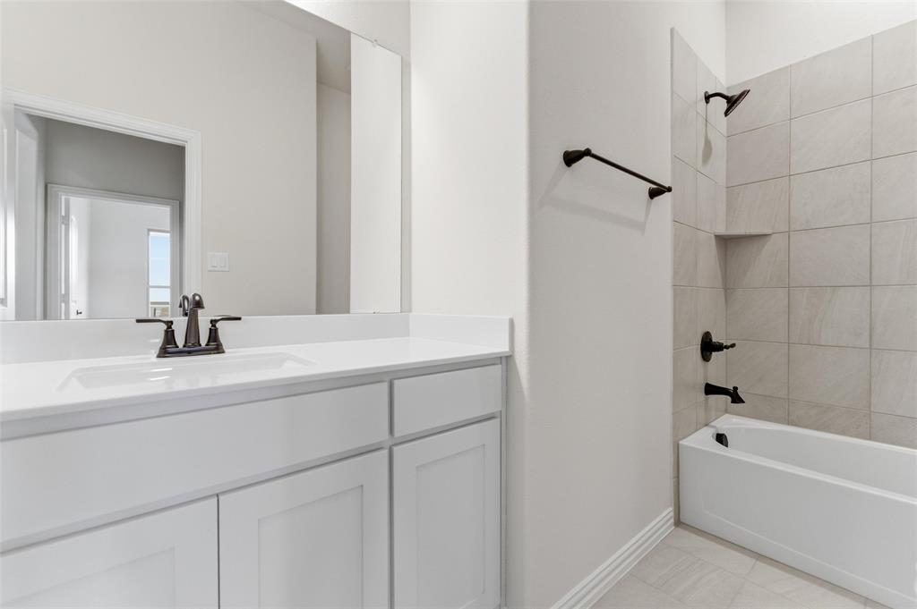 114 Brandywine Trail Rhome, TX 76078 - Photo 9 of 27 a bathroom with a tub sink and mirror