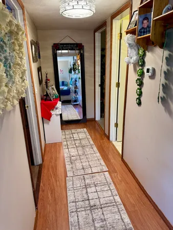 a room with furniture and view of kitchen