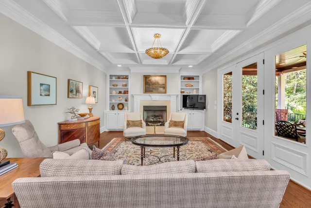 a large kitchen with stainless steel appliances a refrigerator a sink dishwasher a oven with white cabinets and wooden floor