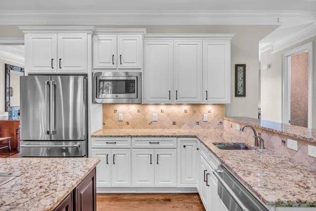 a living room with furniture a flat screen tv and a window