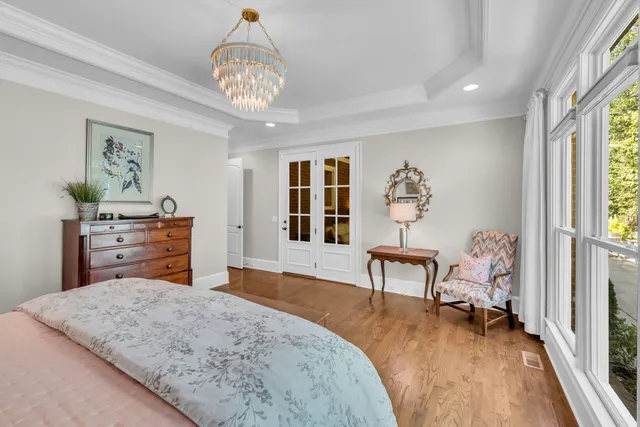a bedroom with furniture and wooden floor