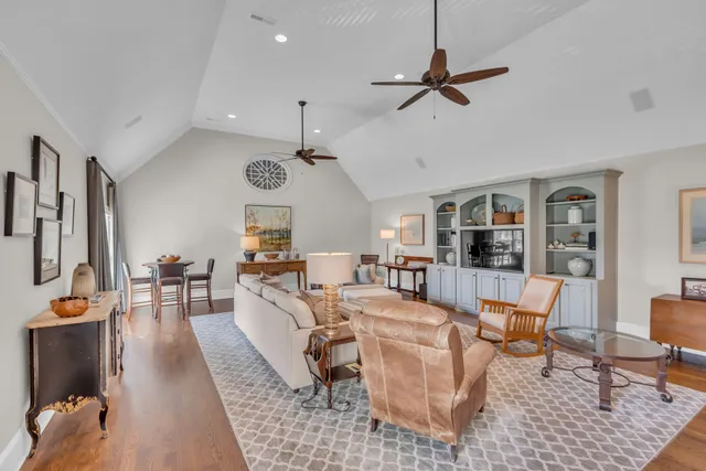 a front view of a house with a yard and green space