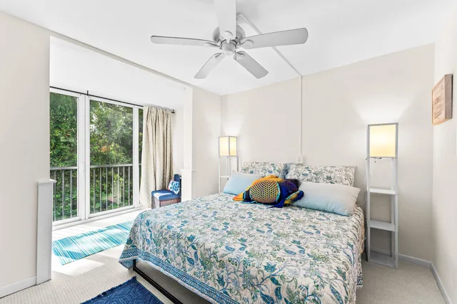 a bedroom with a large bed and a large window