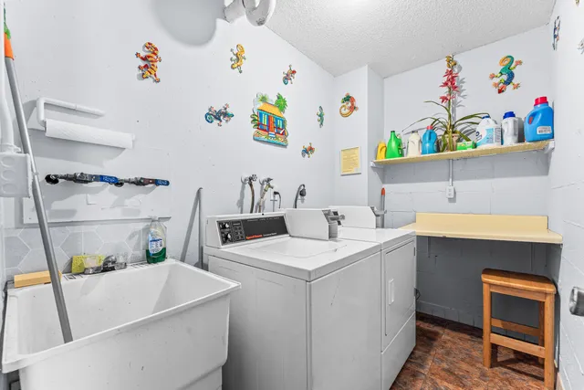 a utility room with a refrigerator a stove a washer and dryer